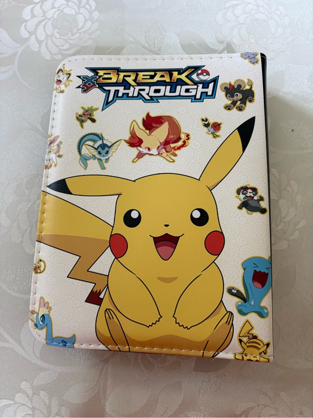 Pokémon 'Break Through' Pikachu Card Binder 50 sleeves, zip closure wrist strap